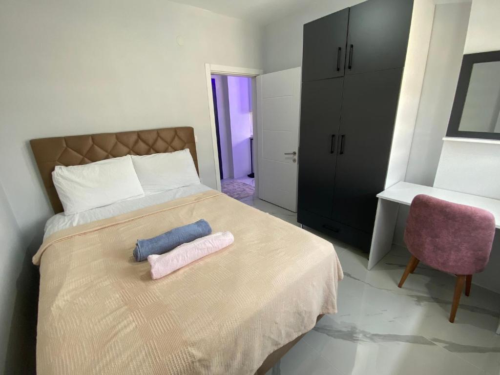a bedroom with a bed with two towels on it at miamia apart otel in Bostancı
