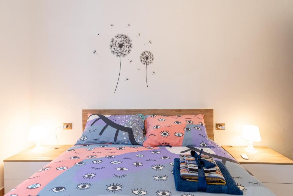 a bedroom with a bed with a dandelion on the wall at Via del Casentino in Reggello