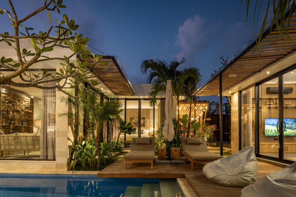 a house with a swimming pool and a patio at Ananda Villa by Hombali in Jimbaran
