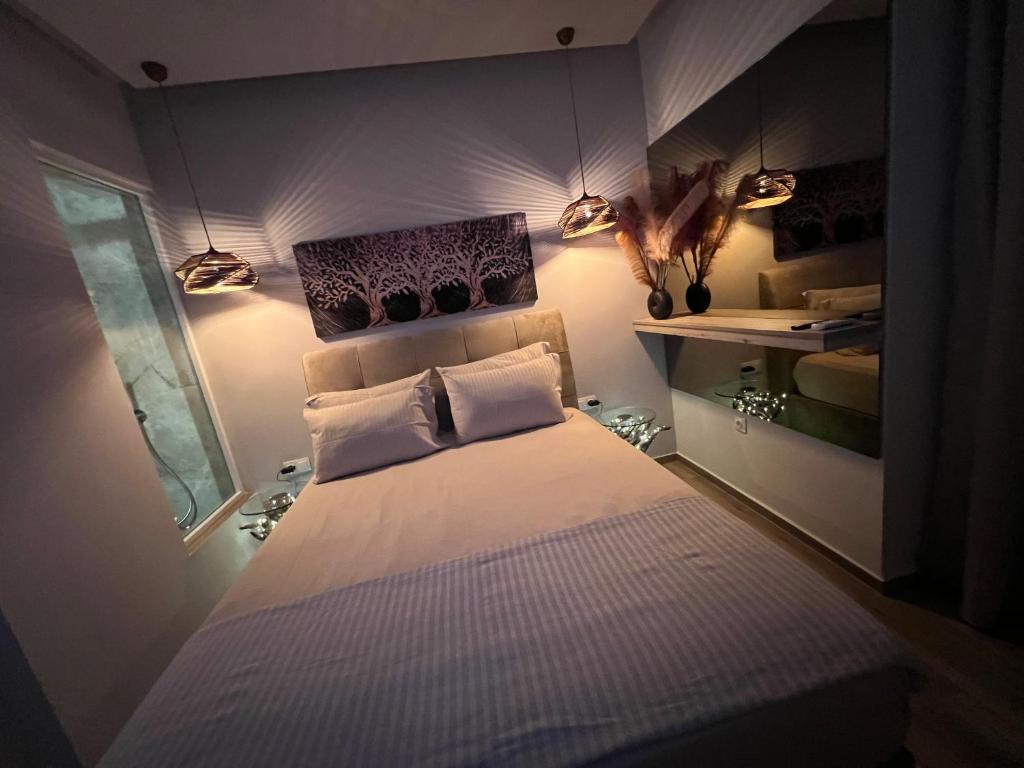 a bedroom with a bed with two pillows and a window at Supreme Secret Suite in Alexandroupoli