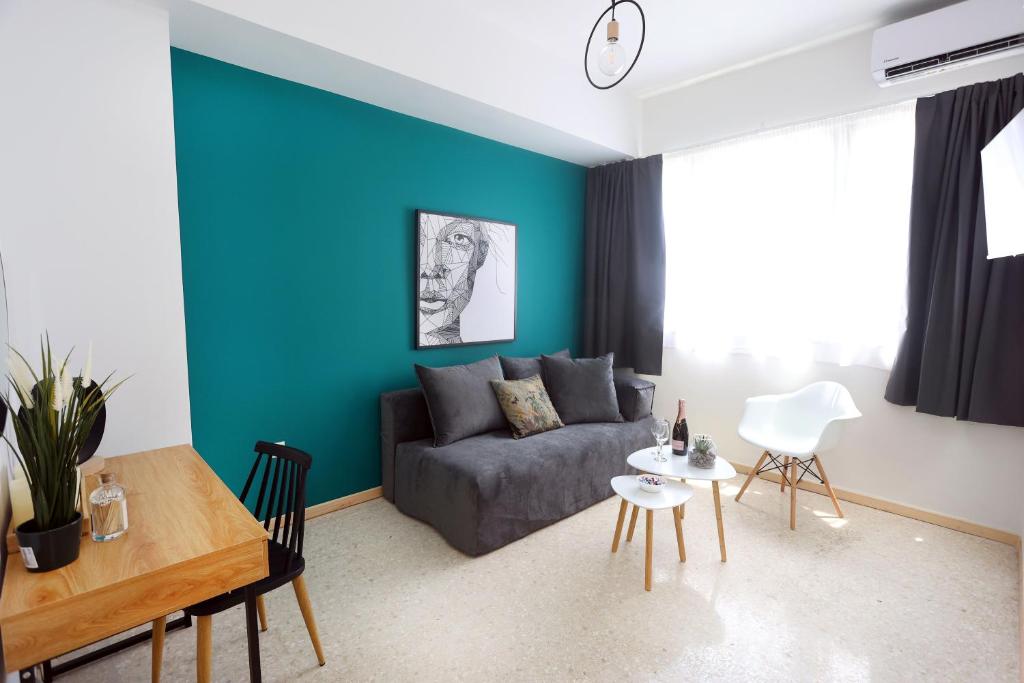 a living room with a couch and a table at Old Town Hall Suites and Apartments in Athens