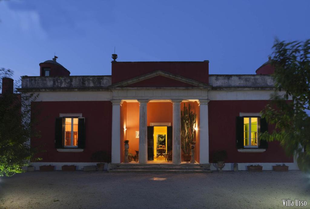 a large red house with columns at Villa Urso bed&breakfast in Monteroni di Lecce