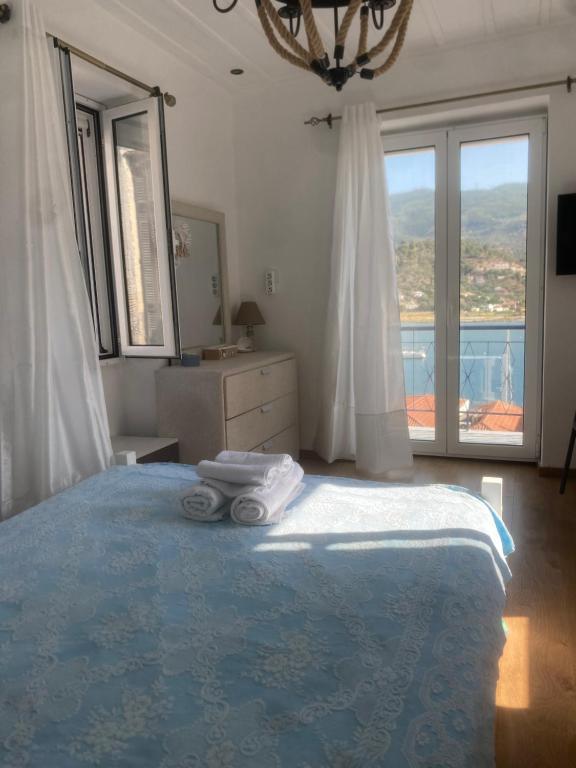 a bedroom with a large bed with towels on it at Veranta Vosporos in Poros