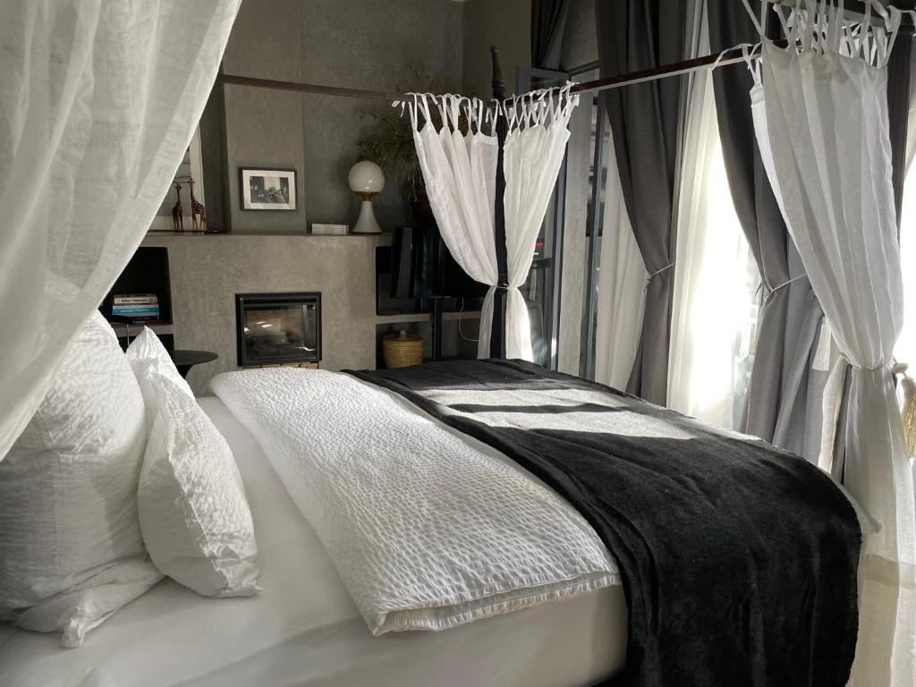 a bedroom with a bed with white pillows and a window at YVES Marrakech in Marrakesh