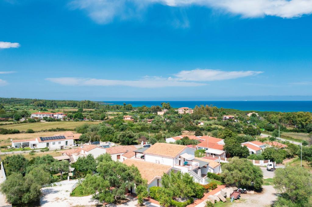 an aerial view of a village with the ocean at I Girasoli in Bari Sardo
