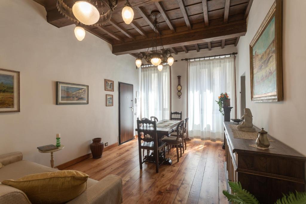 a living room with a table and a dining room at Boutique Ponte Vecchio in Florence