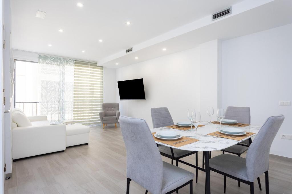 a dining room with a table and chairs and a couch at EDEN RENTALS Top City Center in Santa Cruz de Tenerife