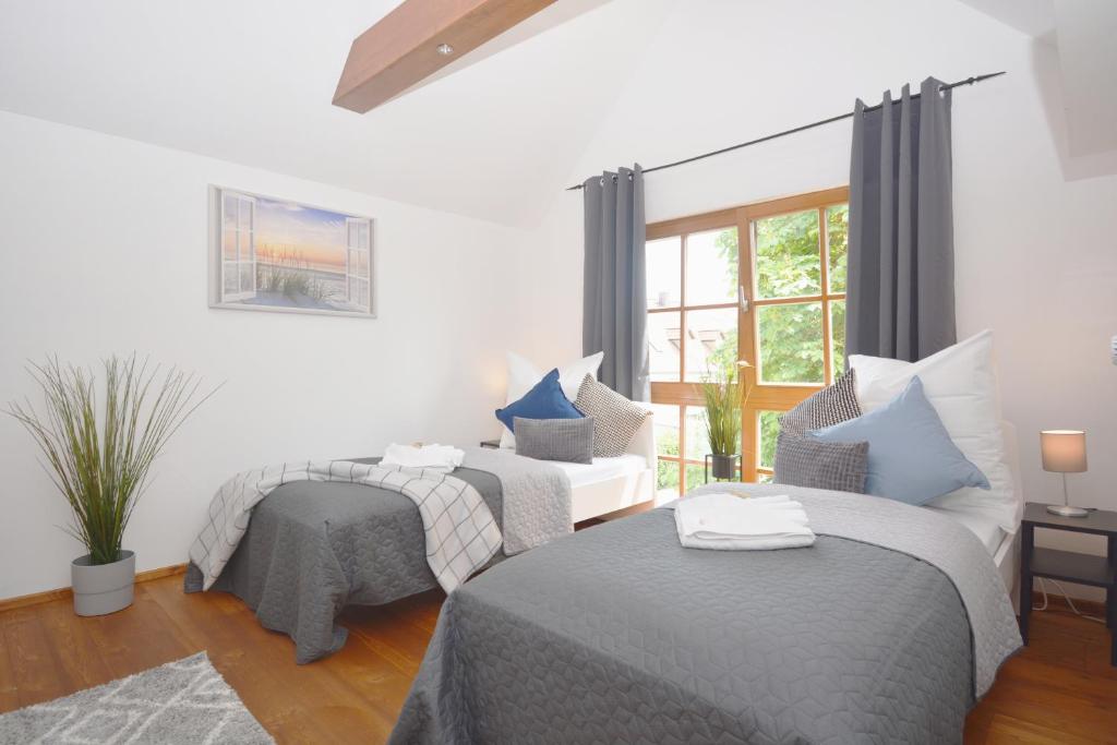 a bedroom with two beds and a window at NUE12-RI Apartment in Zirndorf in Zirndorf