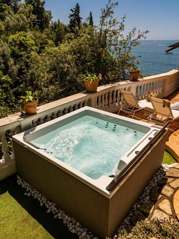 a jacuzzi tub on a patio next to the ocean at Villa Nannina in Positano