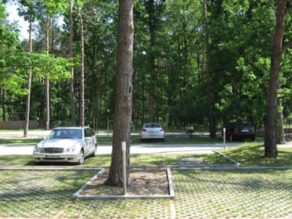 two cars parked in a parking lot with trees at Apartment Südwind App- 9 by Interhome in Zempin