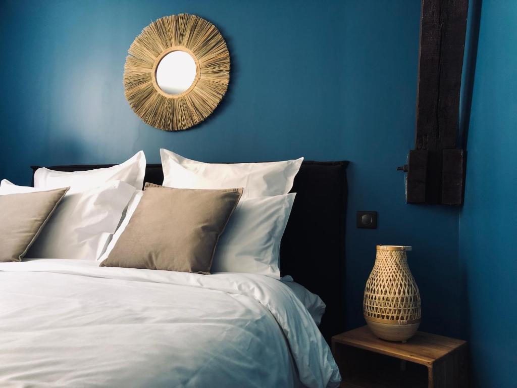 a blue bedroom with a bed and a mirror at Escale à Fécamp 4 étoiles - garage privé in Fécamp