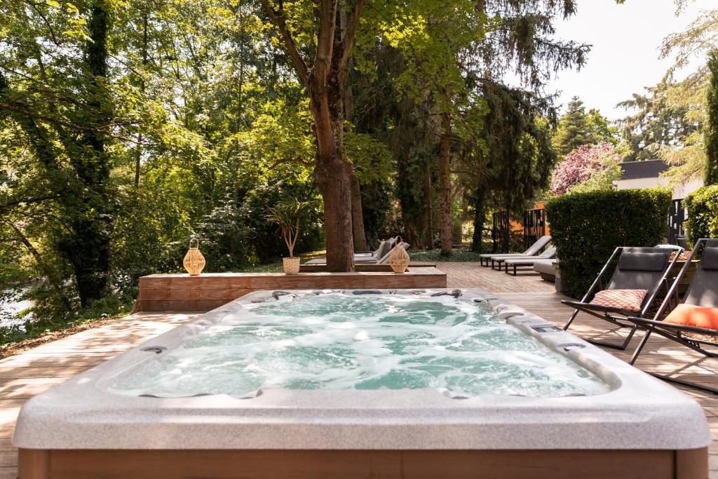 a hot tub in the middle of a yard at H&ocirc;tel Diana Restaurant & Spa by HappyCulture in Molsheim