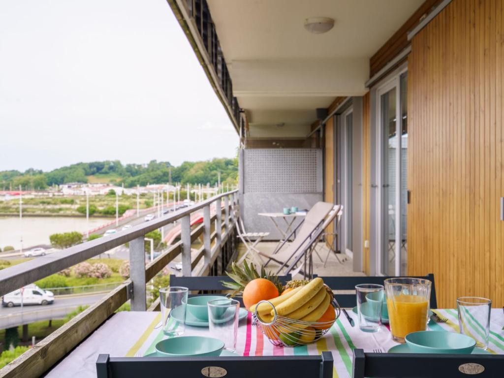 a table with a bowl of fruit on a balcony at Apartment Rivadour 2 by Interhome in Bayonne