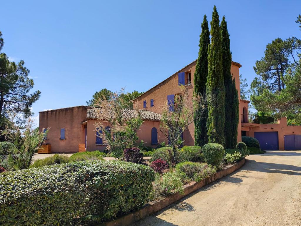 an exterior view of a house with trees and bushes at Holiday Home La Tourelle des Ocres by Interhome in Roussillon