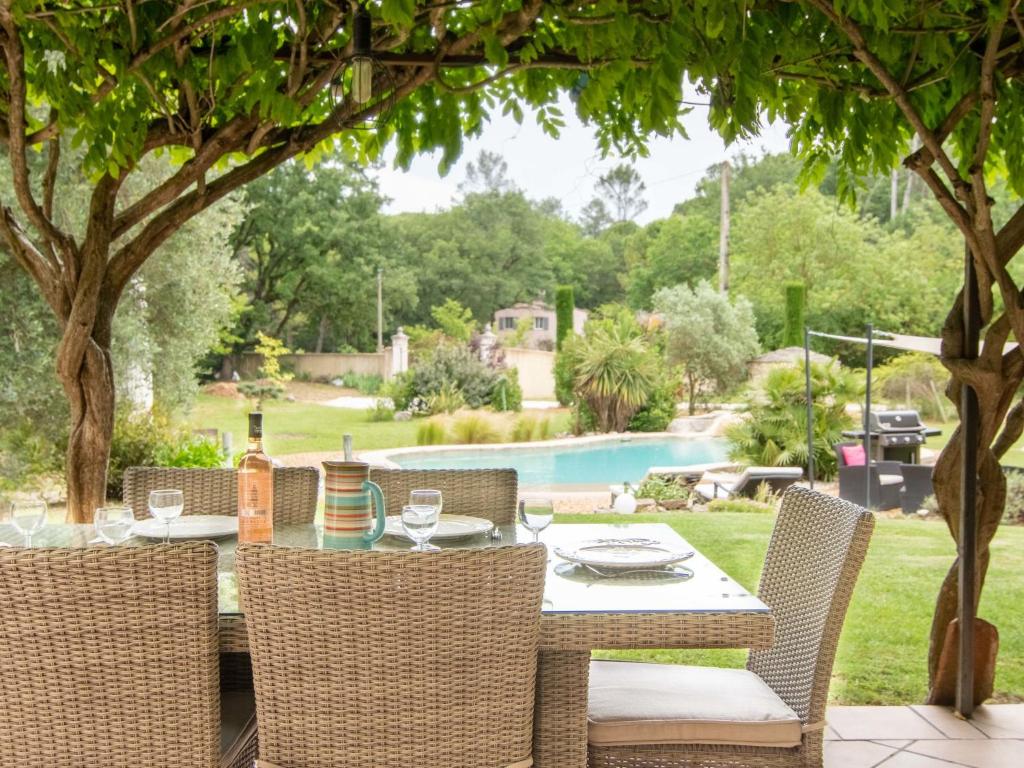 a patio with a table and chairs and a pool at Holiday Home La Bastide by Interhome in Tourves