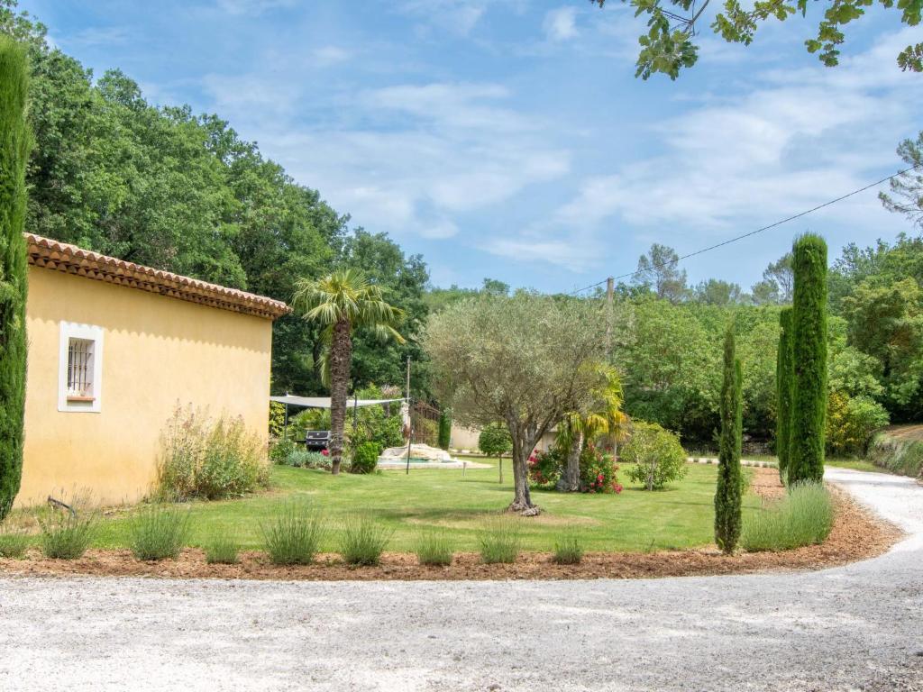 a garden with trees and a house at Holiday Home La Bastide by Interhome in Tourves
