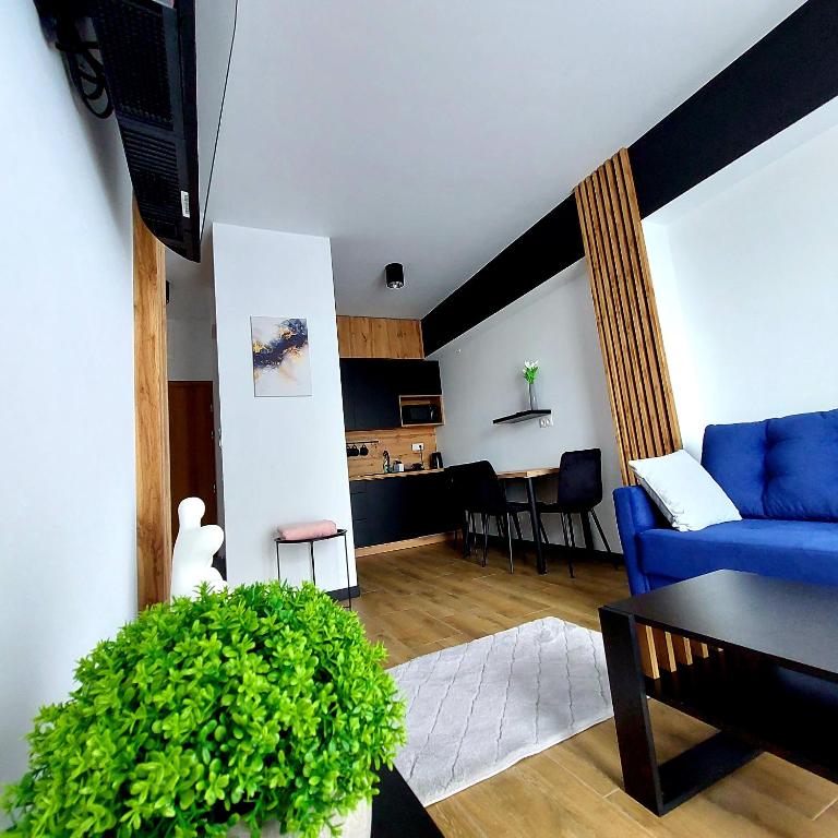 a living room with a blue couch and a table at GOOD PLACE Zator in Zator