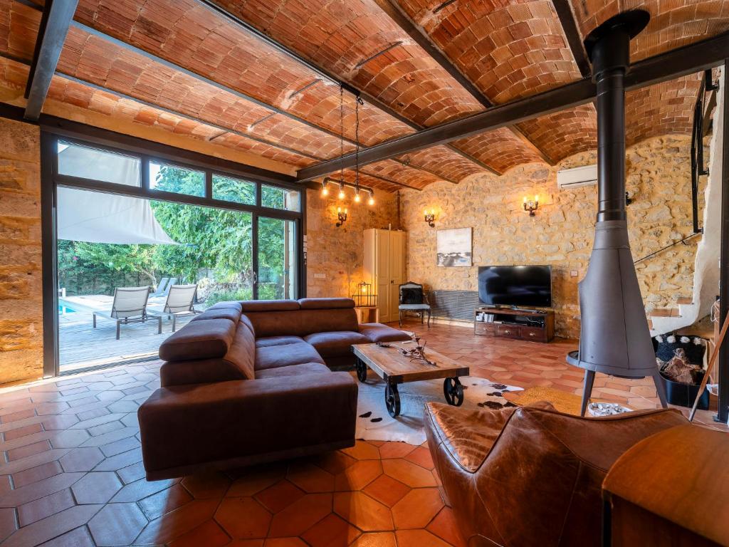 a living room with a couch and a table at Holiday Home Le Mas d&#39;Adélaïs by Interhome in Baron