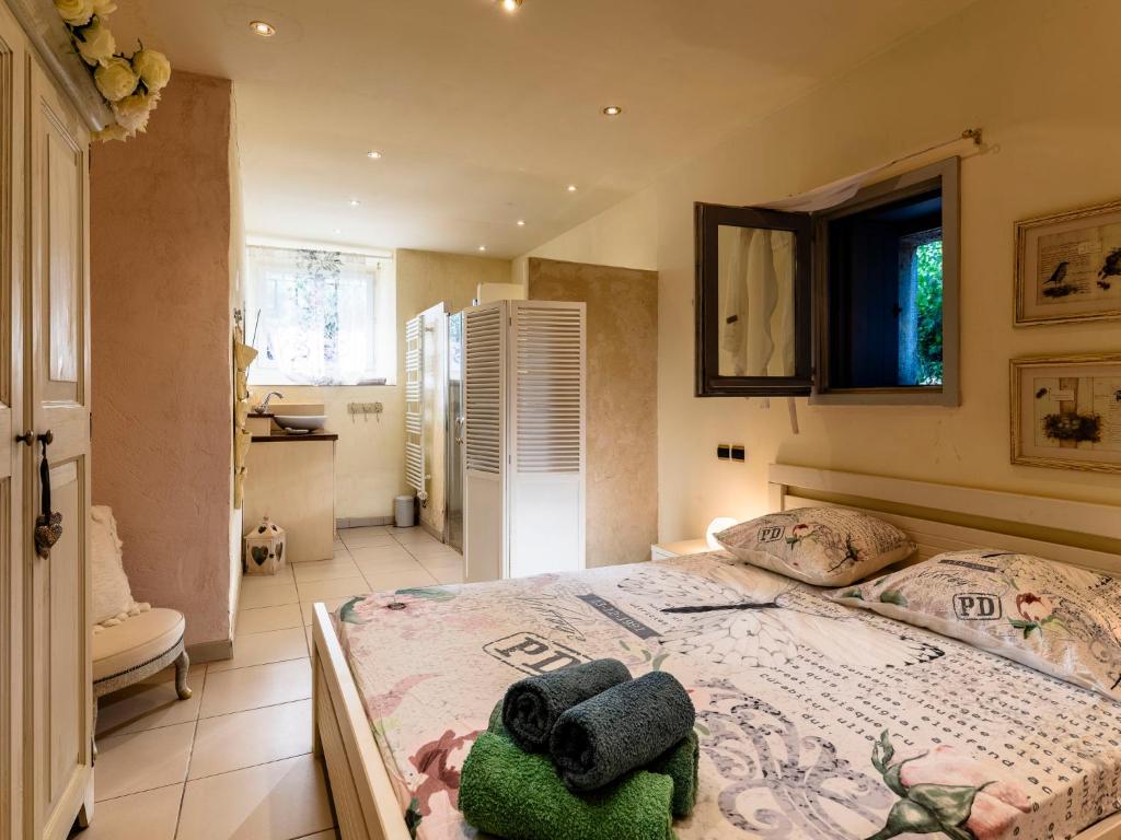 a bedroom with a bed with a stuffed animal on it at Holiday Home Le Mas d&#39;Adélaïs by Interhome in Baron