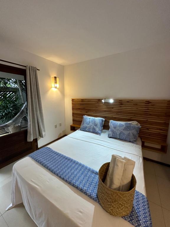 a bedroom with a bed with a basket on it at Pousada Maxitalia Beach in Jericoacoara
