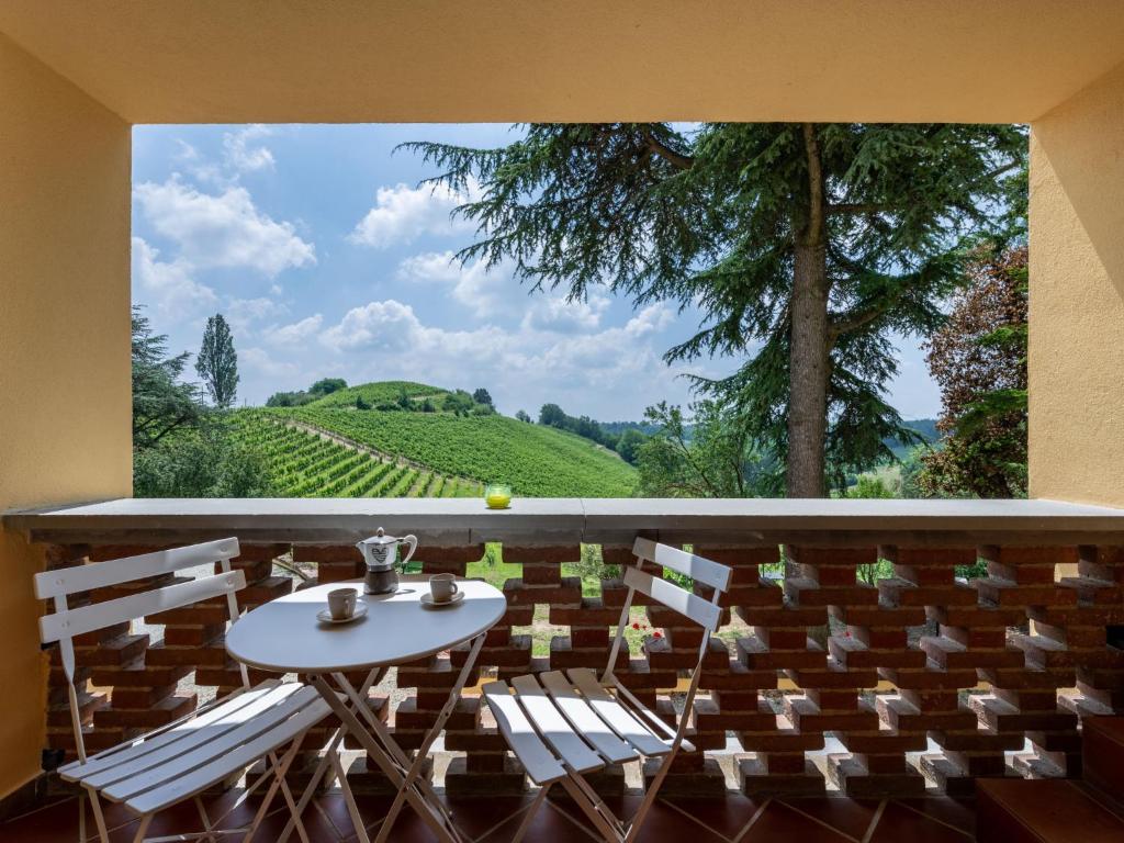 a room with a table and chairs and a large window at Holiday Home Ca' Breia by Interhome in Castel Rocchero