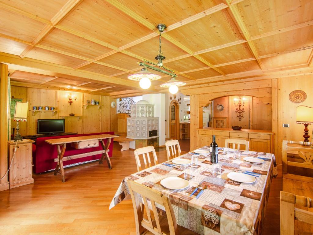 a large dining room with a table in a room at Chalet Cesa Galaldriel-3 by Interhome in Penia