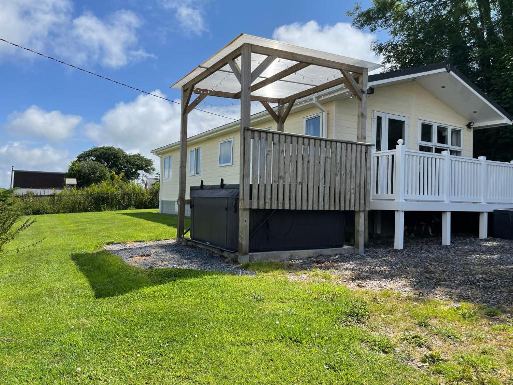 a house with a deck and a gazebo at Mountain View Lodge in Whitland