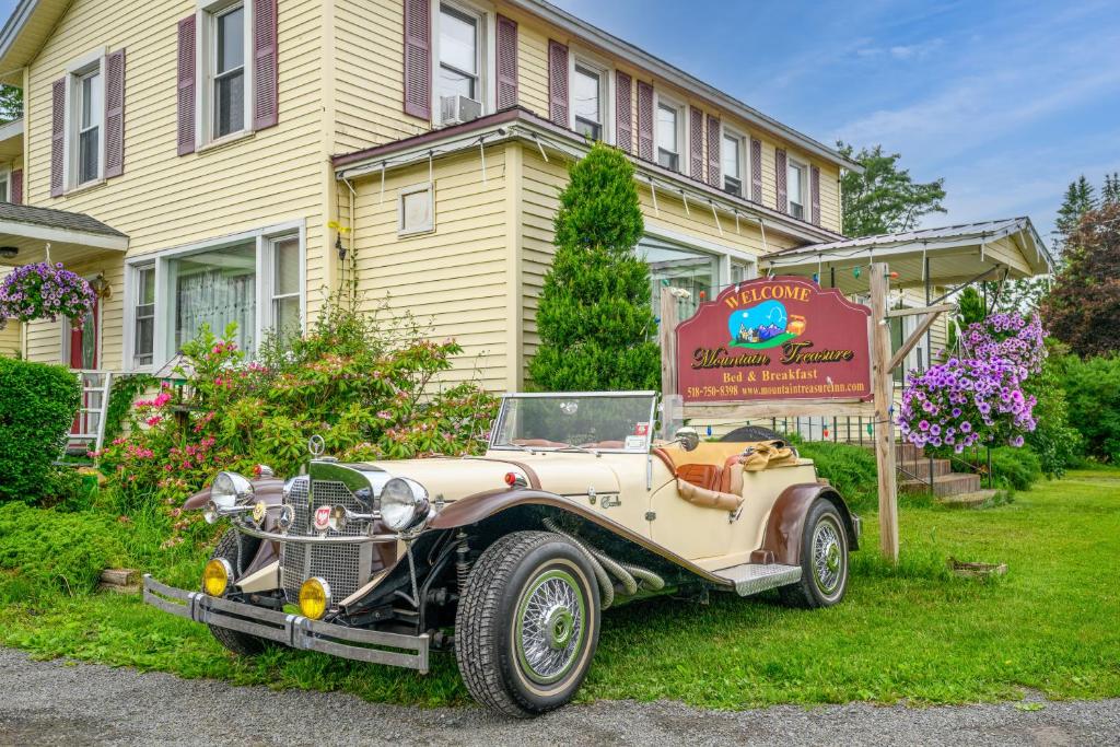 an old car parked in front of a house at Mountain Treasure Bed and Breakfast in Maplecrest