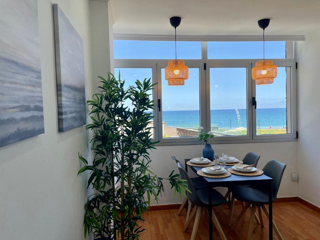 a dining room with a table and a view of the ocean at Las Canteras View Home in Las Palmas de Gran Canaria