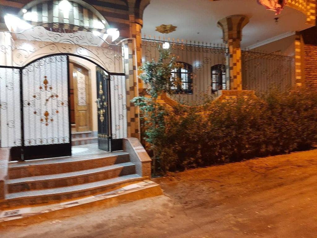 an entrance to a building with stairs and a gate at El radwan in Jazīrat al ‘Awwāmīyah