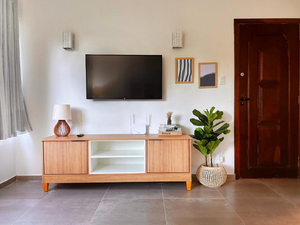 a entertainment center with a television on a wall at Local 102 Apartment in Rio de Janeiro