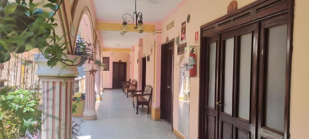 a corridor of a building with a hallway with chairs at Hotel Chaparral in Panajachel