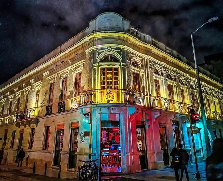 um edifício com luzes coloridas no lado dele em 201 Aparta Studio Boutique en mansión siglo XIX em Bogotá