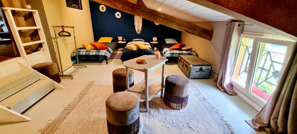 um quarto com um sofá e uma mesa num quarto em Gîte des écuries de la paguere em Aurignac