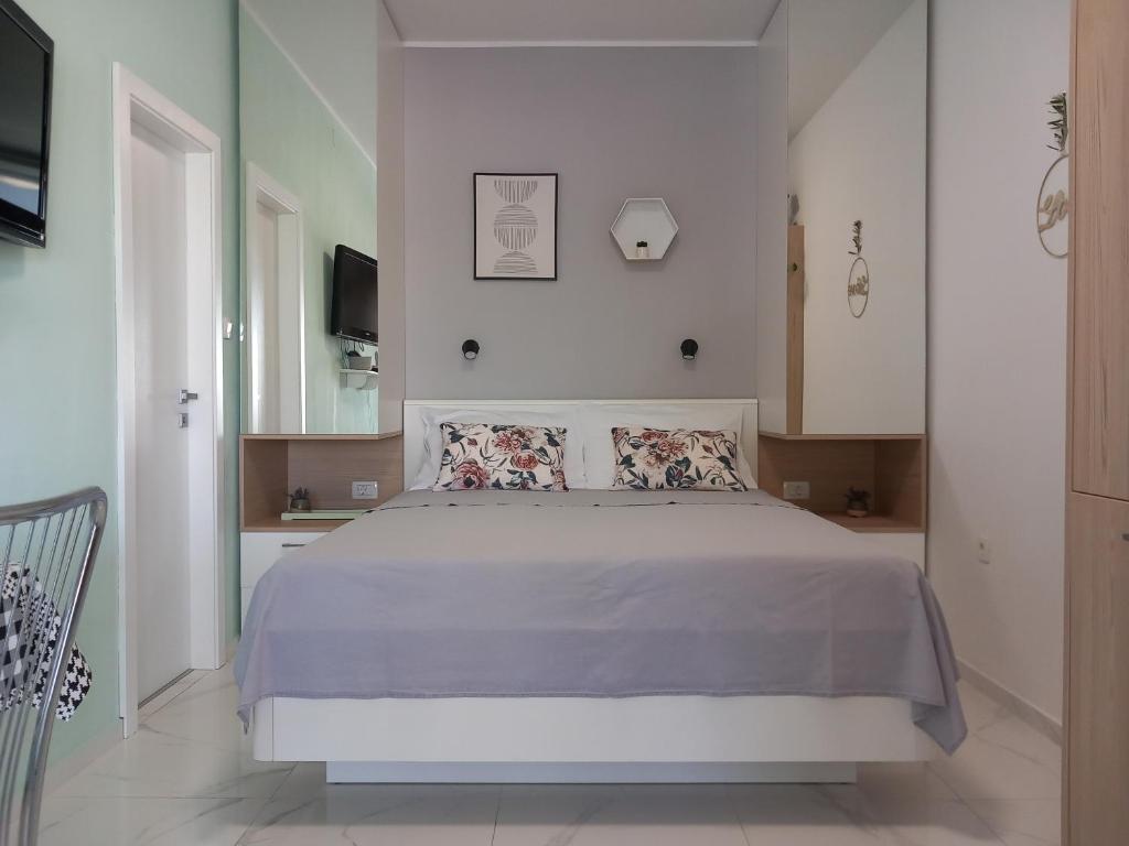 a bedroom with a large bed and a tv at Room and terrace in Krk