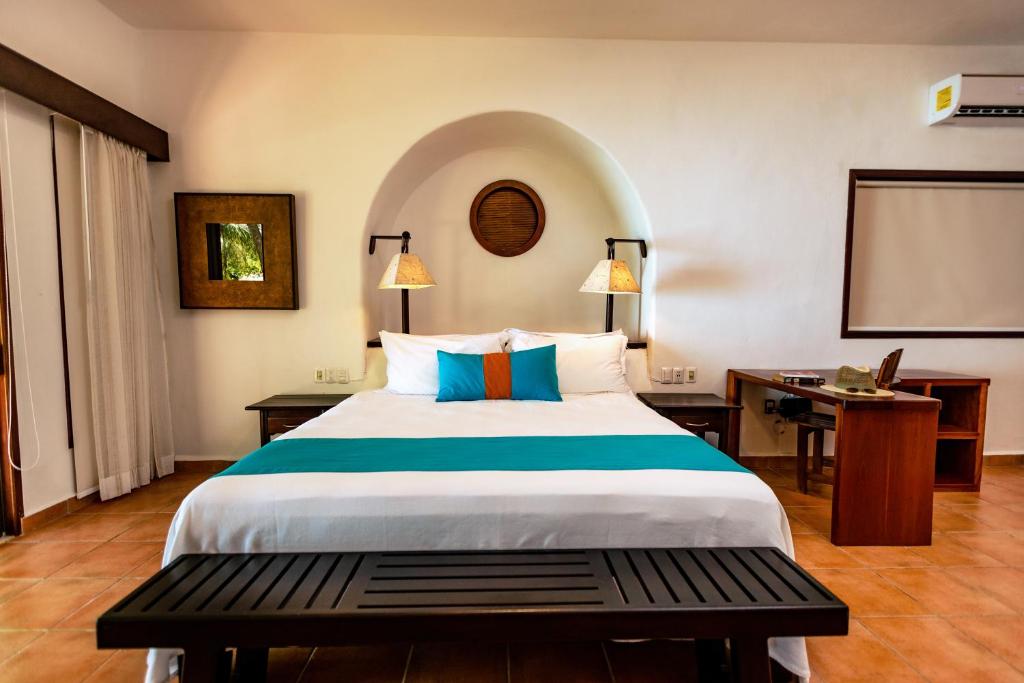 Postel nebo postele na pokoji v ubytování Hotel Rancho Encantado