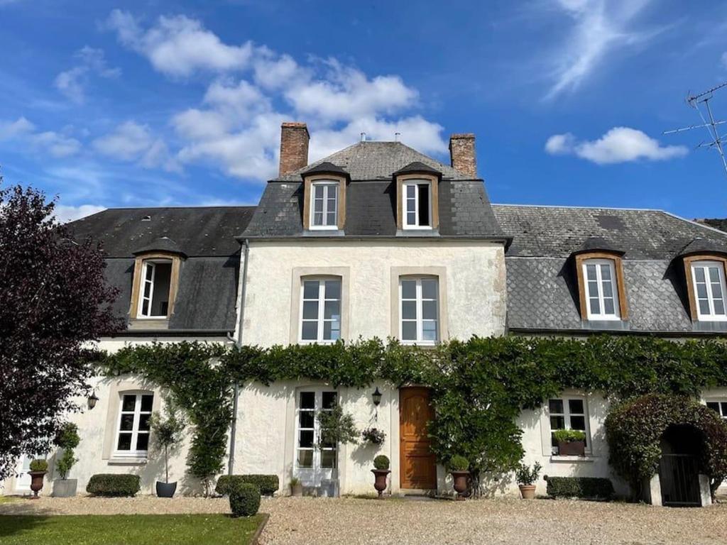 a large white house with a black roof at Maison de Famille près de Montargis - Élégance et Confort en Forêt - FR-1-590-354 in Paucourt