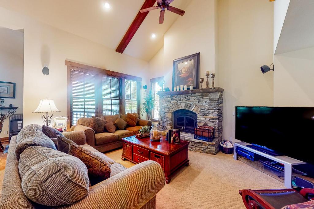 a living room with two couches and a fireplace at Lodges 1136 in Mammoth Lakes