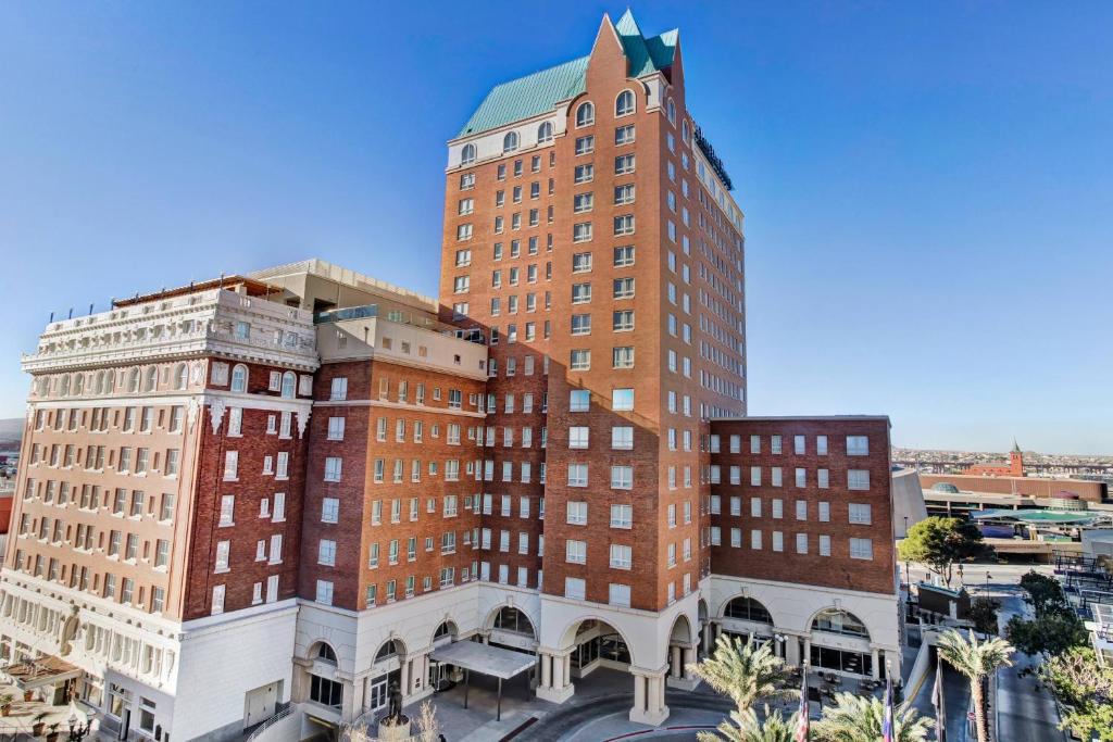 a tall red brick building with a clock tower at Hotel Paso Del Norte, Autograph Collection in El Paso