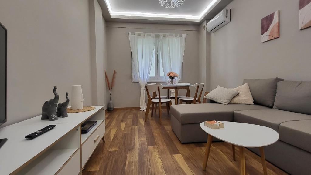 a living room with a couch and a table at Traveller's Spot cozy apt in Thessaloniki