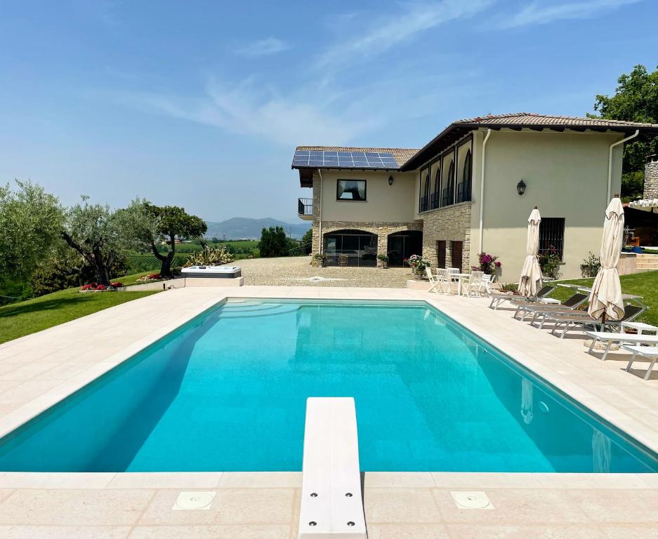 a swimming pool in front of a house at Heart House Franciacorta in Erbusco