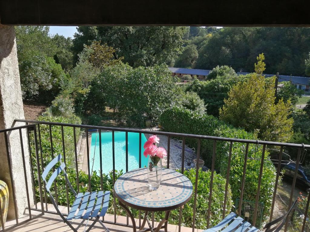 a table with a vase of flowers on a balcony at Chez Isabelle in Saint-Paul-de-Vence