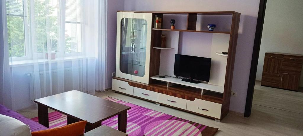 una sala de estar con un centro de entretenimiento con TV de pantalla plana en 2х кімнатна квартира у Львові поряд з залізничним вокзалом en Leópolis