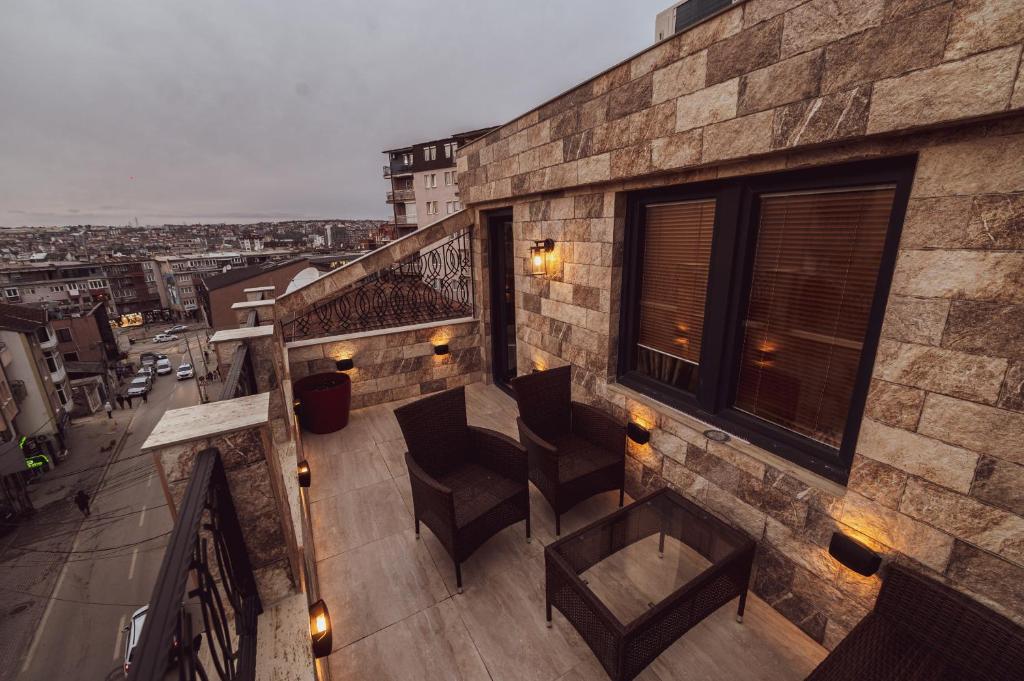 a balcony with chairs and a view of a city at Hotel Premium in Pristina