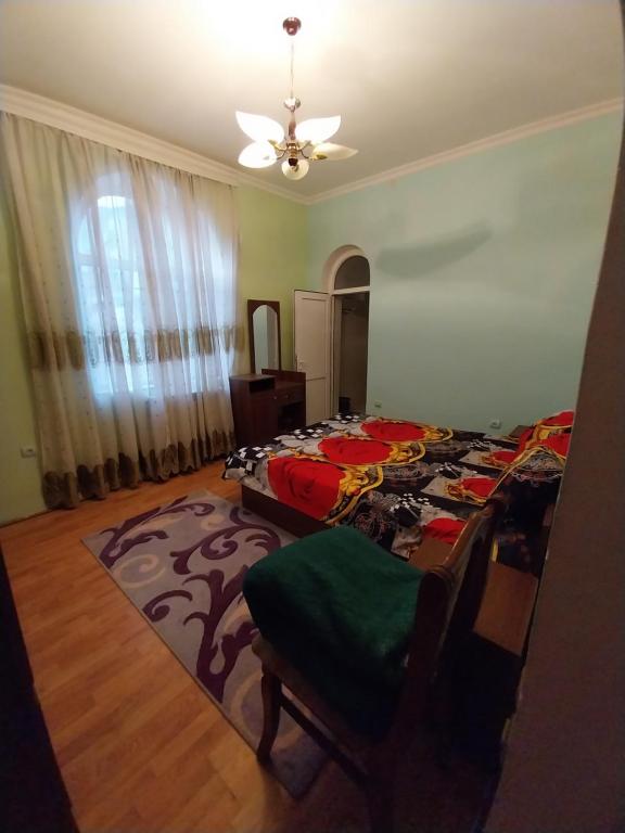 a bedroom with two beds and a ceiling fan at LALE VILLA in Baku