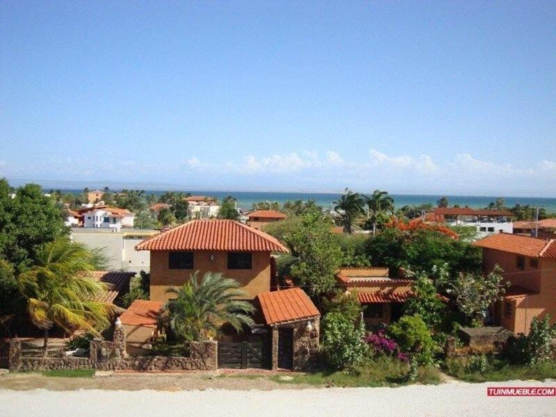 a house with a view of the ocean at El Yaque Ranch in El Yaque