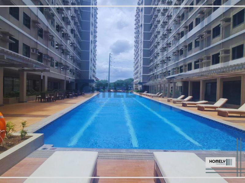 a large swimming pool in the middle of a building at Homely - SMDC Green 2 Residences, Dasmarinas City in Pasong Bayog