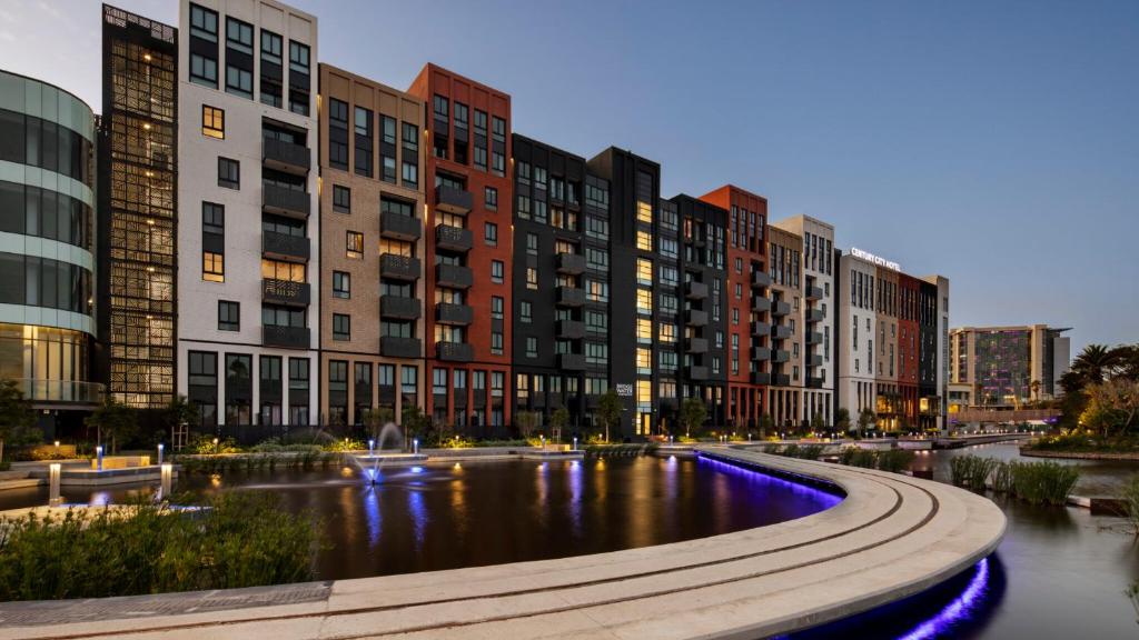a city with tall buildings and a river with purple lights at 101 Bridgewater Apartment in Cape Town