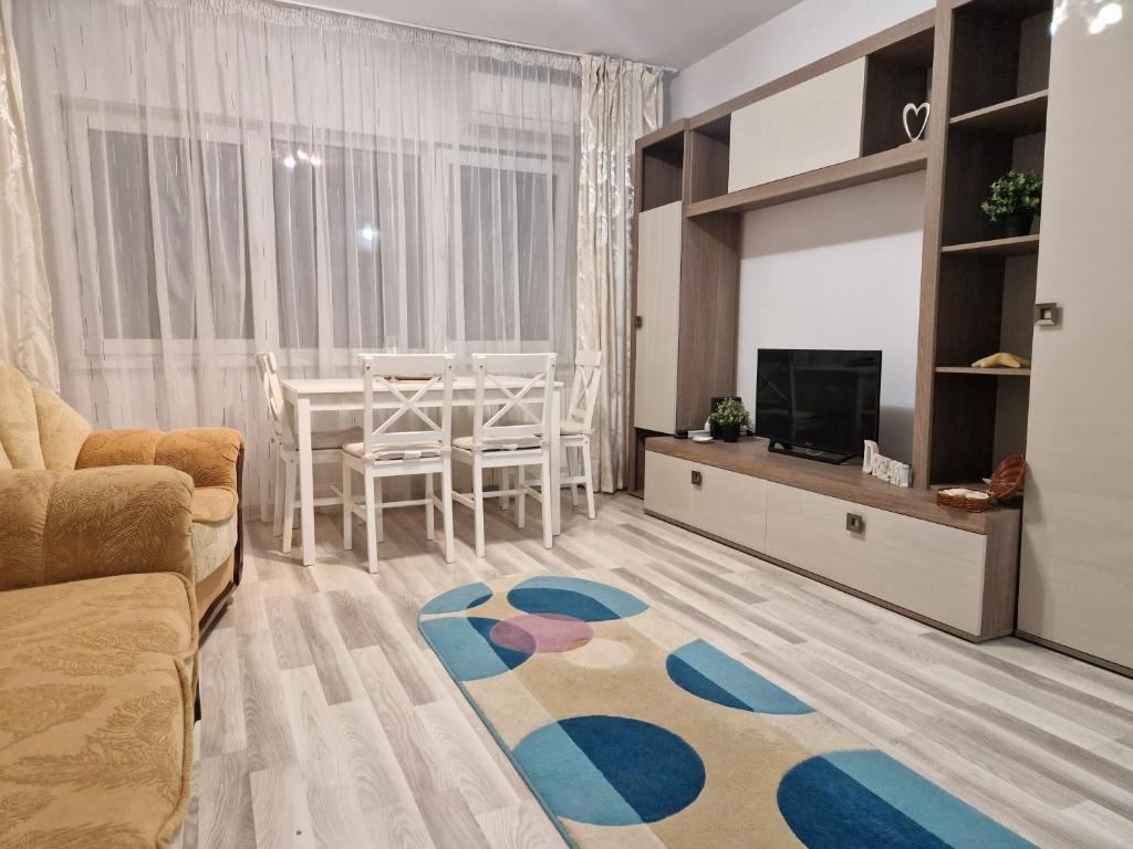 a living room with a couch and a tv and a table at City Center Apartment in Bucharest