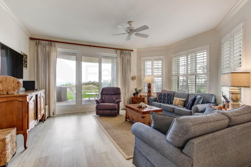 a living room with a couch and a tv at Ocean Place Condo in Amelia Island